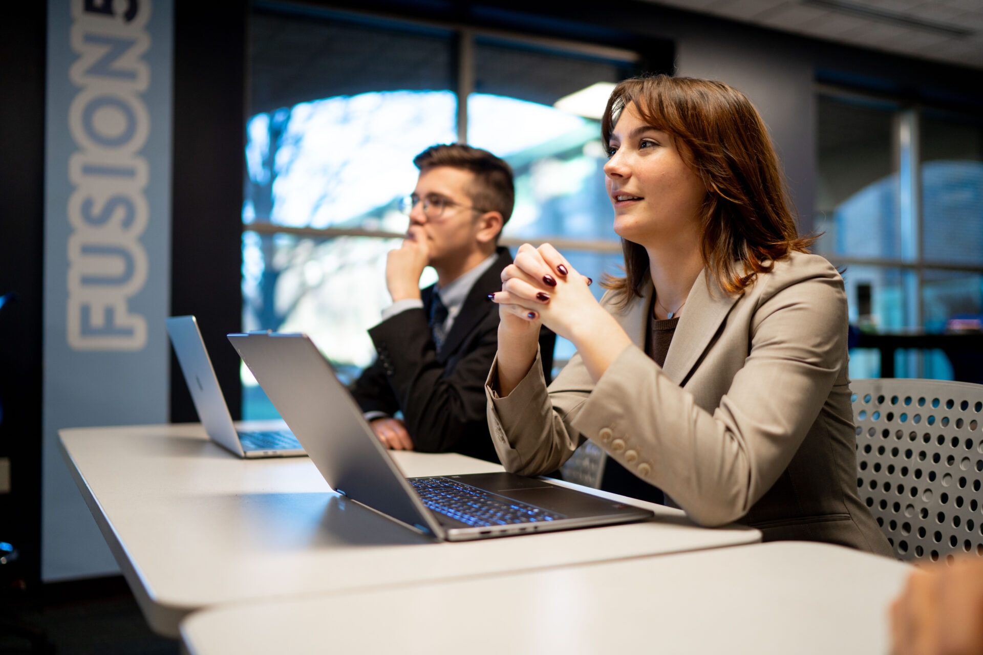 Two students listening intently