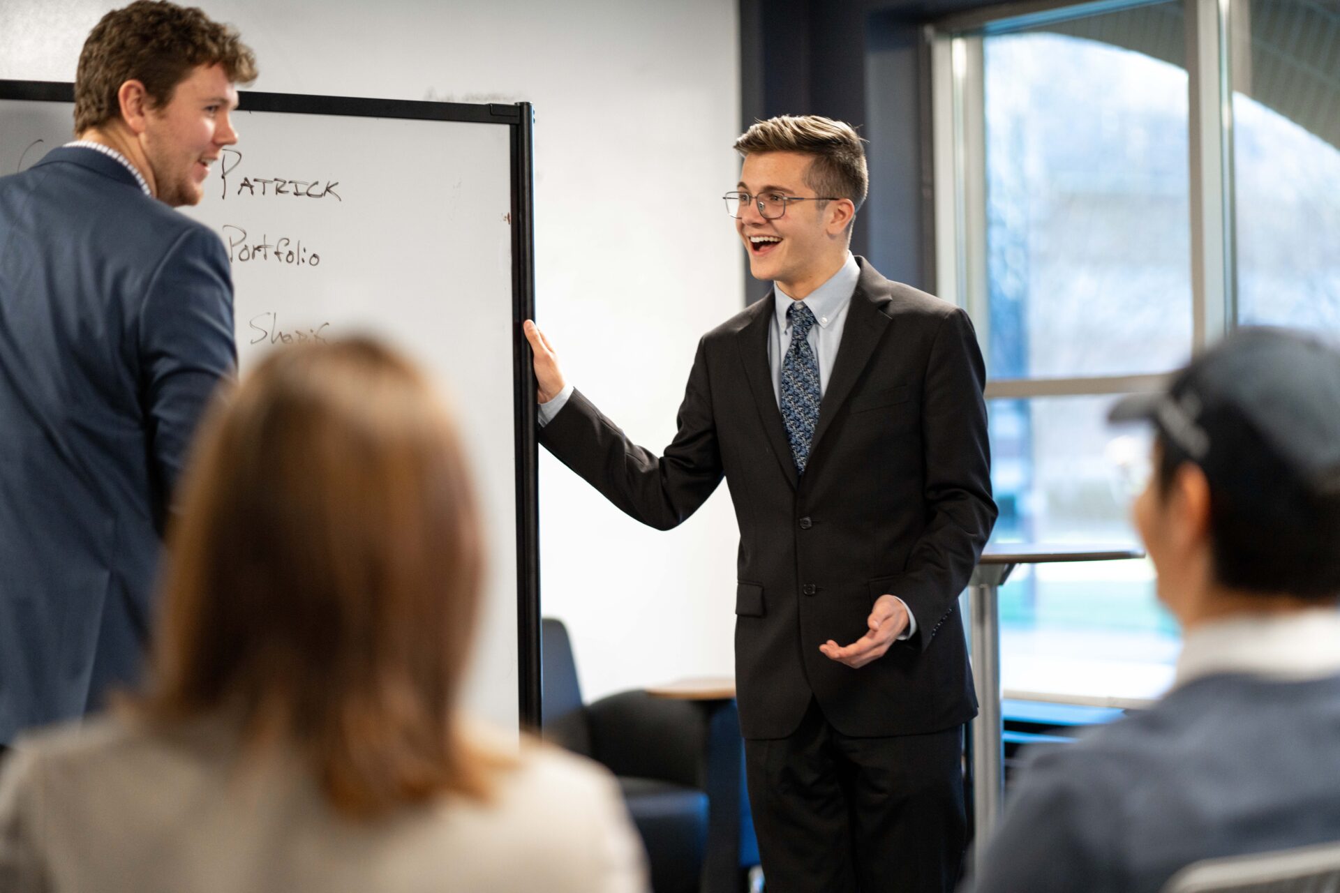 Business students enjoying a presentation in front of class